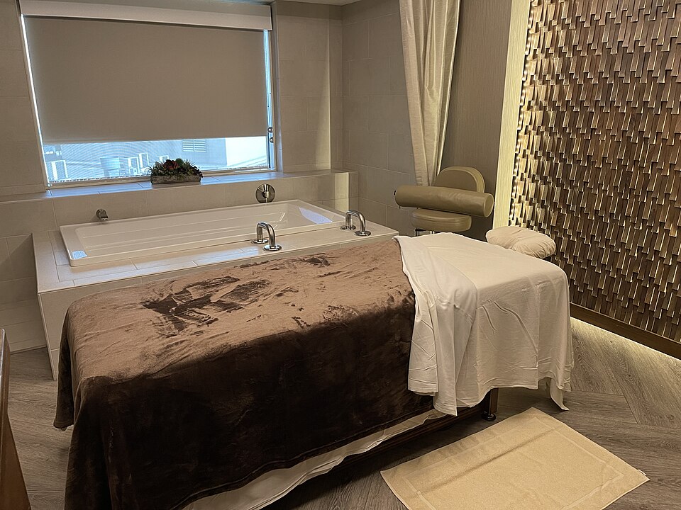 A quiet spa treatment room with a made-up treatment table